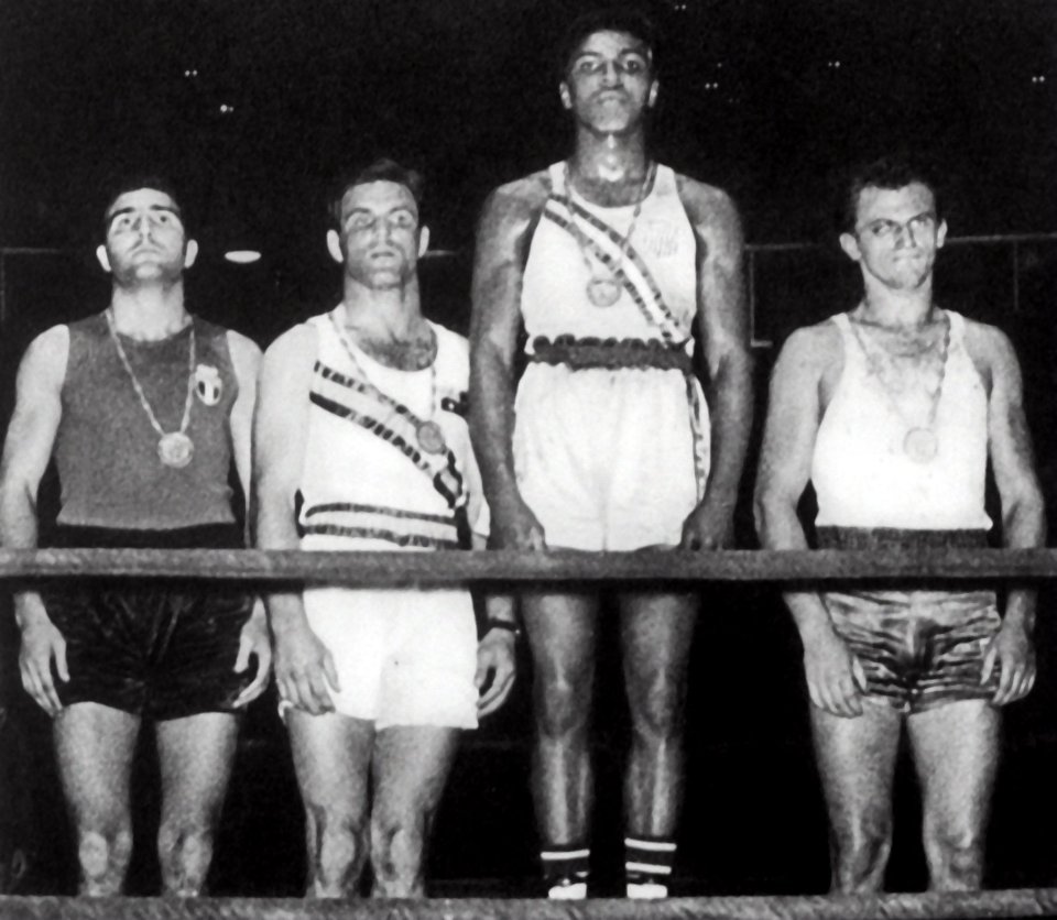  Young champion ... aged just 18, Ali, second from right, won gold at the 1960 Games in Rome by beating Pole Zbigniew Pietrzykowski