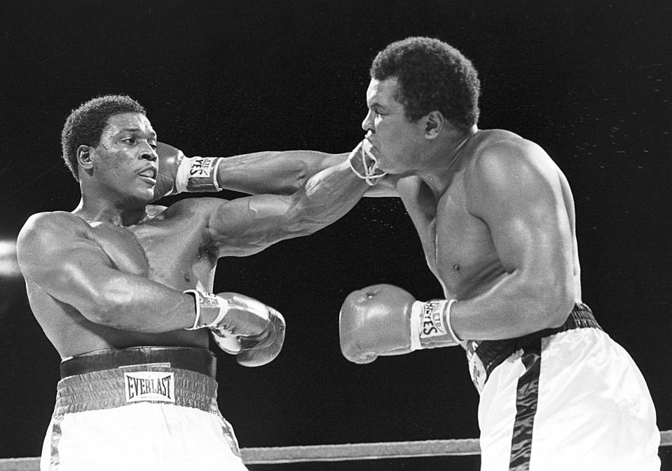  Hard knock life ... Ali, pcitured right taking on Trevor Berbick, communicated by blinking as the thousands of jabs to the jaw and his illness had taken a terrible toll on the legend