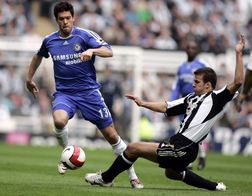  Newcastle's Steven Taylor slides in on former Chelsea midfielder Michael Ballack