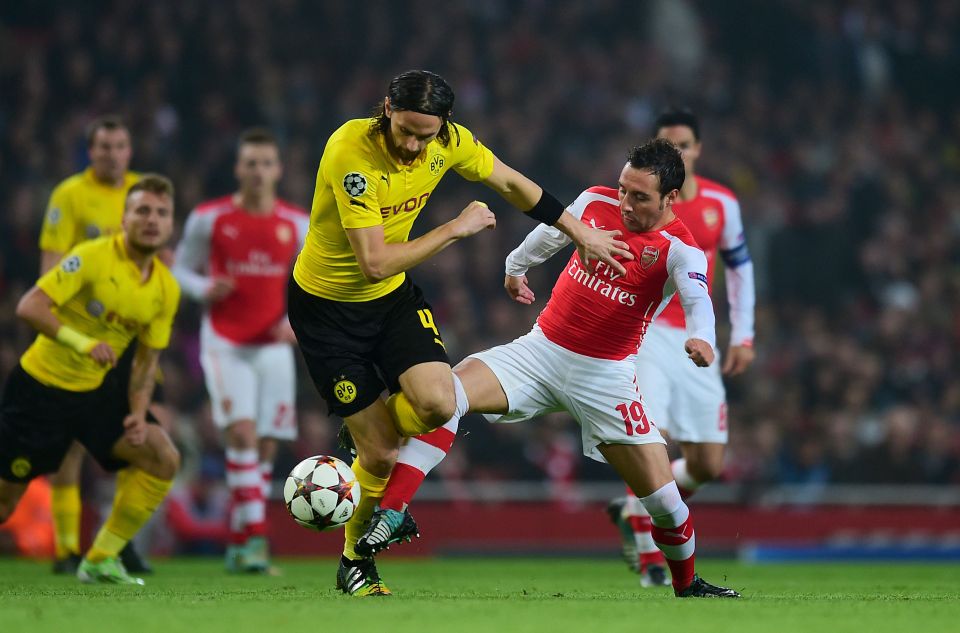  Neven Subotic up against Arsenal's Santi Cazorla in a Champions League clash