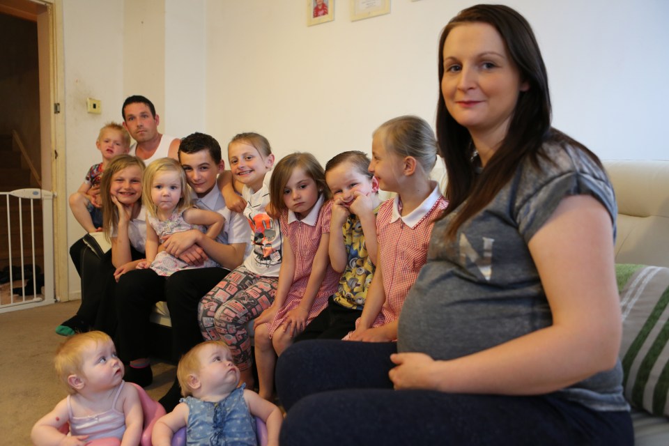  Cheryl with her twelve children and ex-husband Rob - who she dumped after he had a threesome with his cousin and a random woman