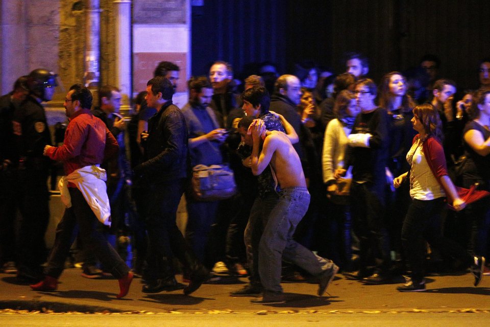  Concert-goers run for cover outside the Bataclan venue which was also targeted by Islamic State on evening of November 13