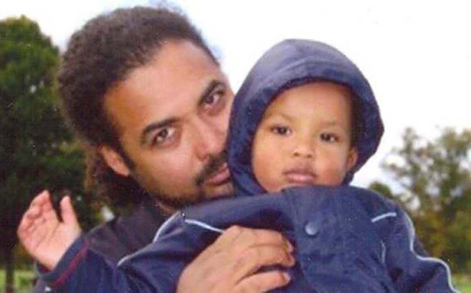  The killer pictured with his son Amon. He appeared in court via video link  to admit three counts of murder