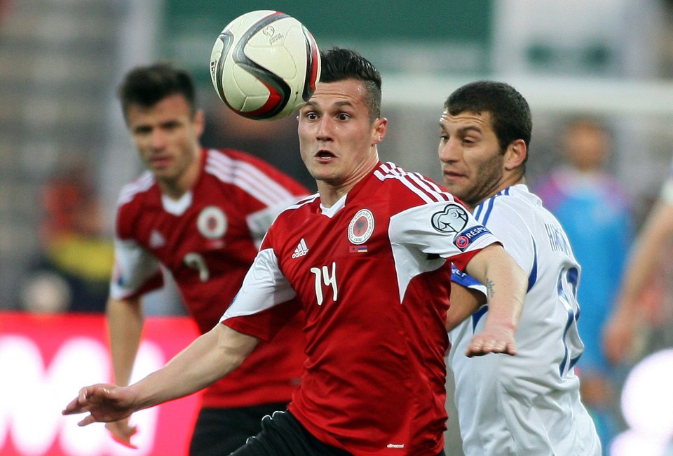  Taulant Xhaka looks to hold off a challenge during Albania's game with Armenia