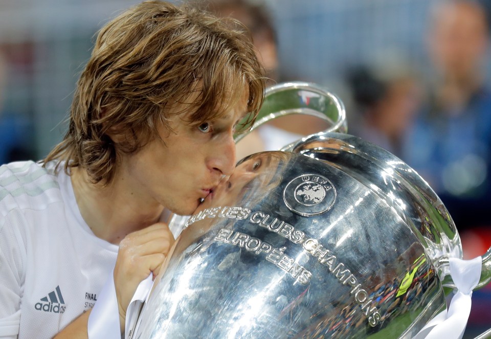 Luka Modric celebrates with the Champions League trophy he won with Real Madrid last month