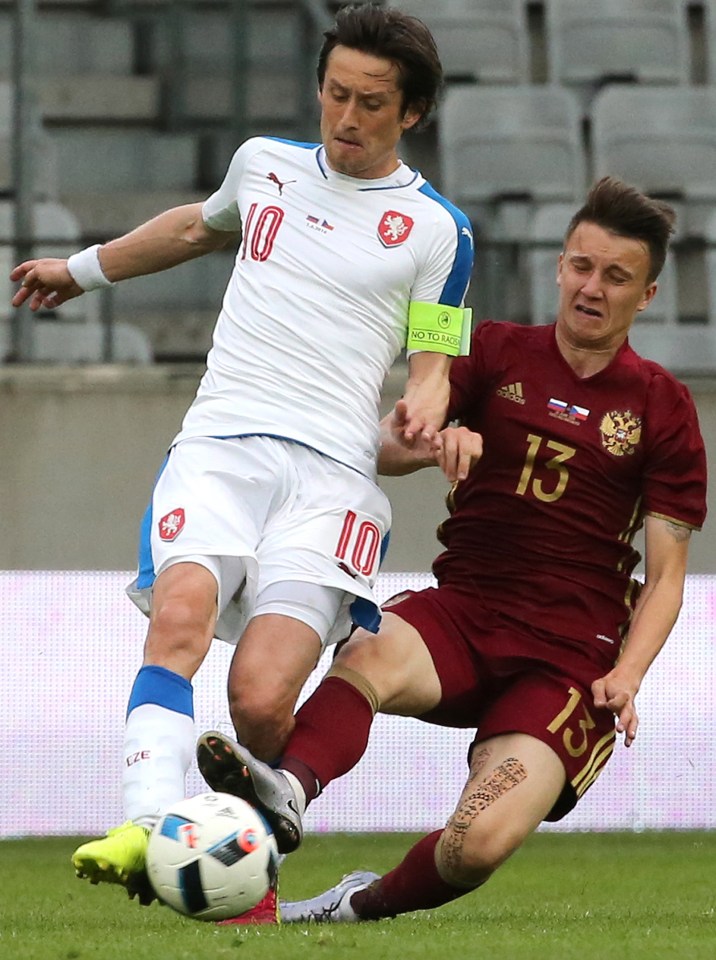 Tomas Rosicky challenges Alexander Golovin for the ball in the friendly