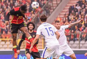 Belgium's Michy Batshuay goes for a header