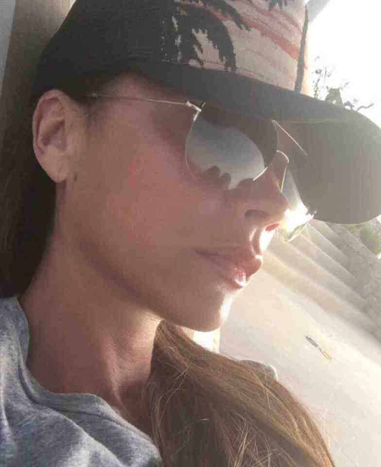  Victoria kept it casual in a t-shirt, shades and baseball cap while she topped up her tan