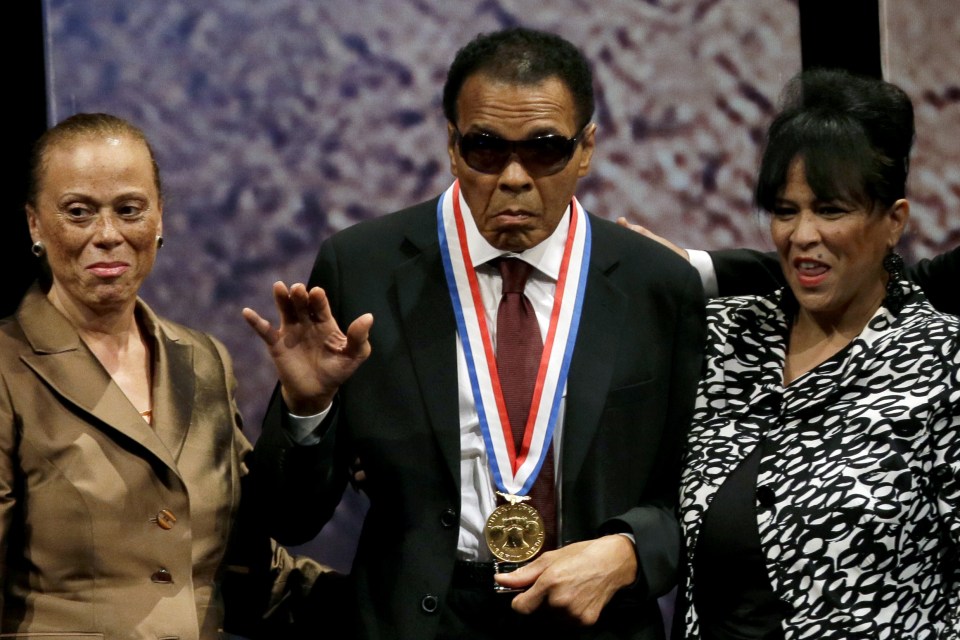  Muhammad Ali, center, waves alongside his wife Lonnie Ali, left, and his sister-in-law Marilyn Williams, right, after receiving the Liberty Medal during a ceremony at the National Constitution Center in Philadelphia