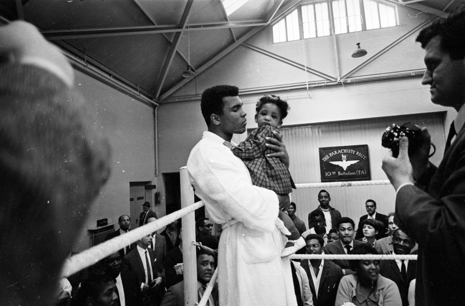  Ali meets eight-month old Maria Morin in a training session at the Territorial Army Gymnasium at White City, London, 1966