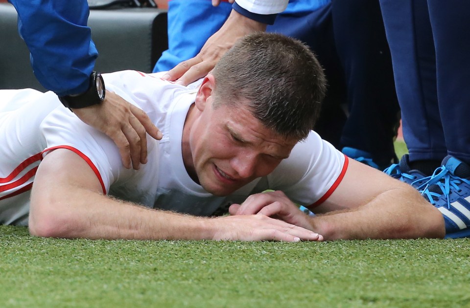  Igor Denisov breaks down after picking up the injury against Serbia