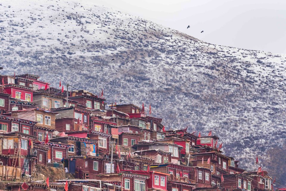  The rugged and harsh landscape is apparent as the snow-capped peaks of the surrounding mountains emerge over the township