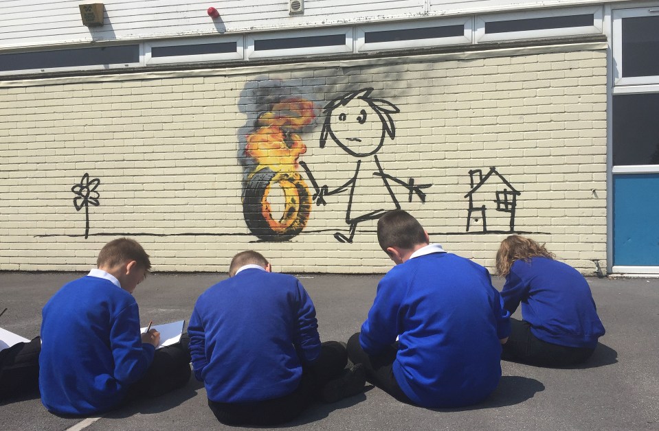 Children from Bridge Farm Primary school copy the Banksy mural 