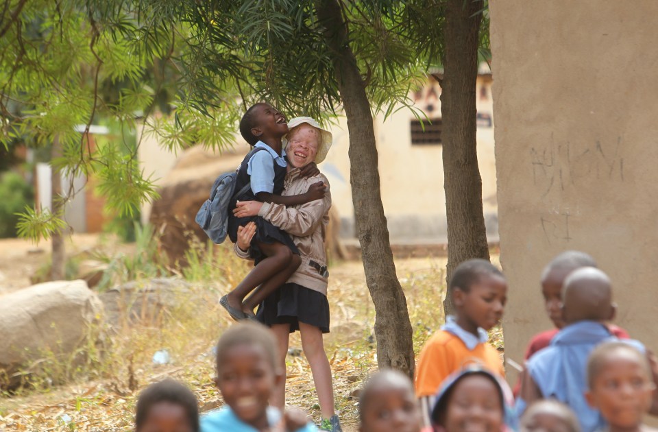  Mina Godfrey, 13, plays with her friends at her school in Machinga