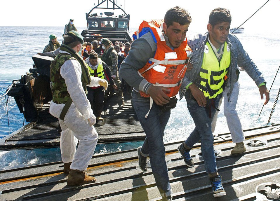  Members of HMS Bulwark are pictured helping to save migrants from a perilous journey in a wooden boat, during Operation Weald. HMS Bulwark was responsible for the rescue of thousands of migrants fleeing Africa