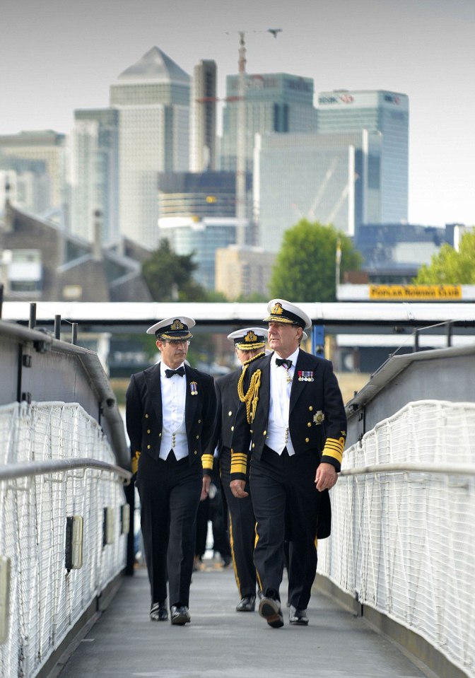  With the banking district of London at Canary Wharf towering in the background, the First Sea Lord, Admiral Sir George Zambellas, boards the Cutty Sark in Greenwich, London