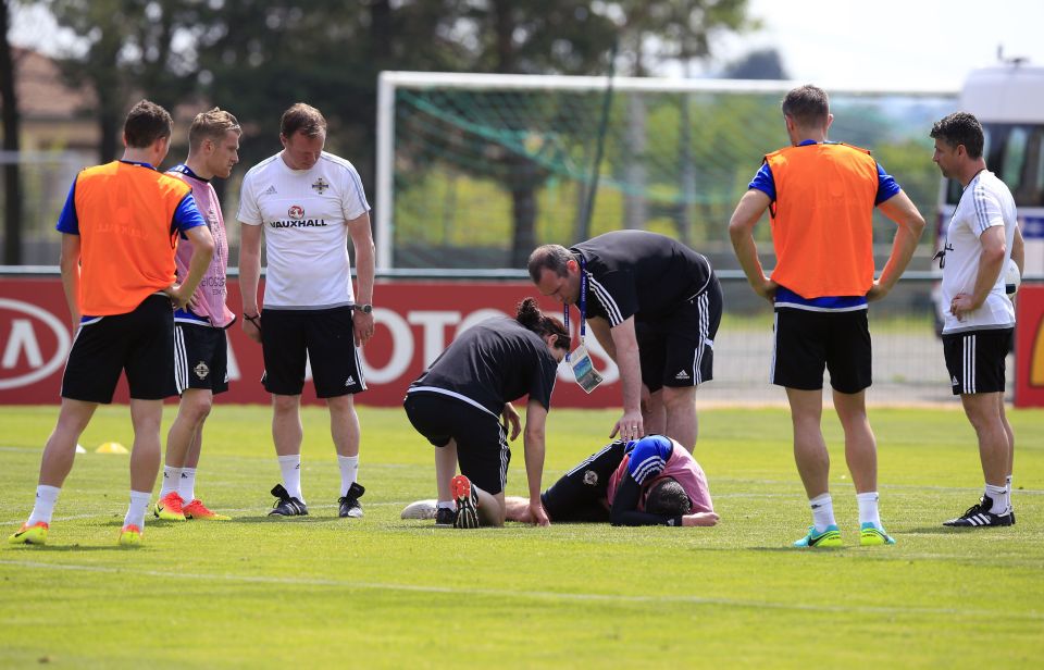 Kyle Lafferty is treated by Northern Ireland medics after a sliding tackle