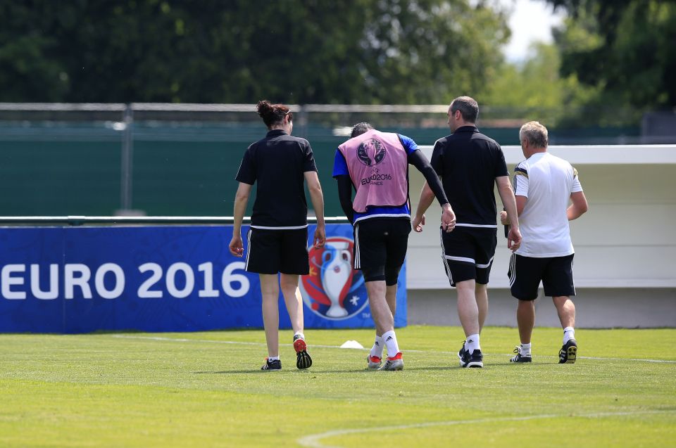 Kyle Lafferty limps away to the changing room assisted by the medical staff