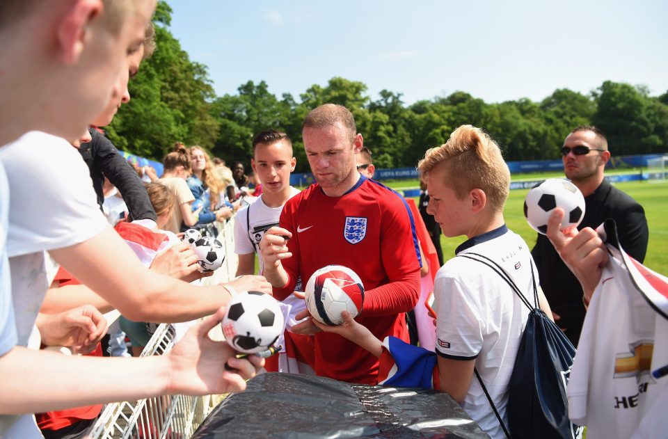  Captain Wayne Rooney signs autographs after the England training session