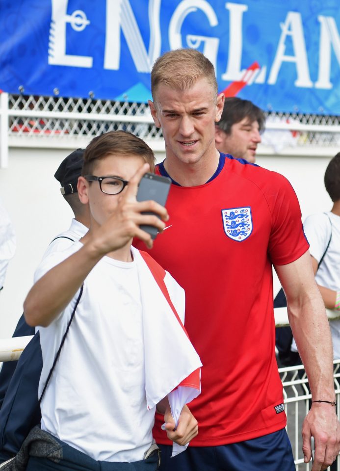 Goalkeeper Joe Hart poses for a picture with a young fan at Englands base in Chantilly