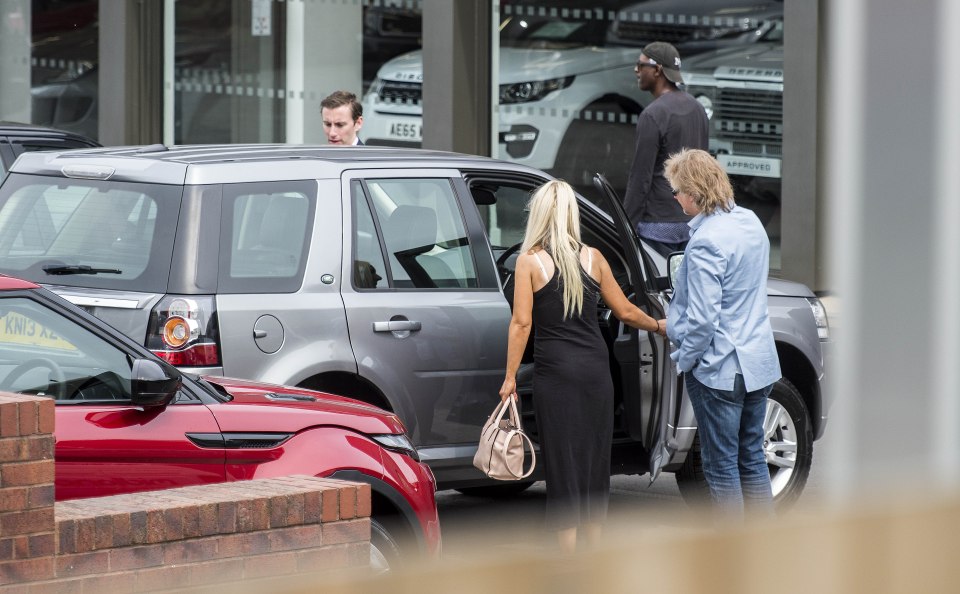  Marie appeared to be trying out the expensive motor as she spoke with a car salesman