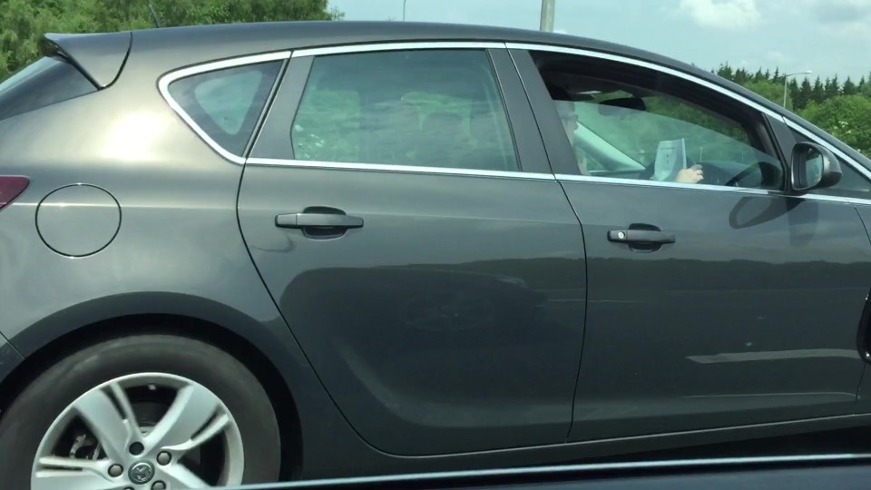  The driver appeared to be reading a piece of paper which she had propped up against the wheel