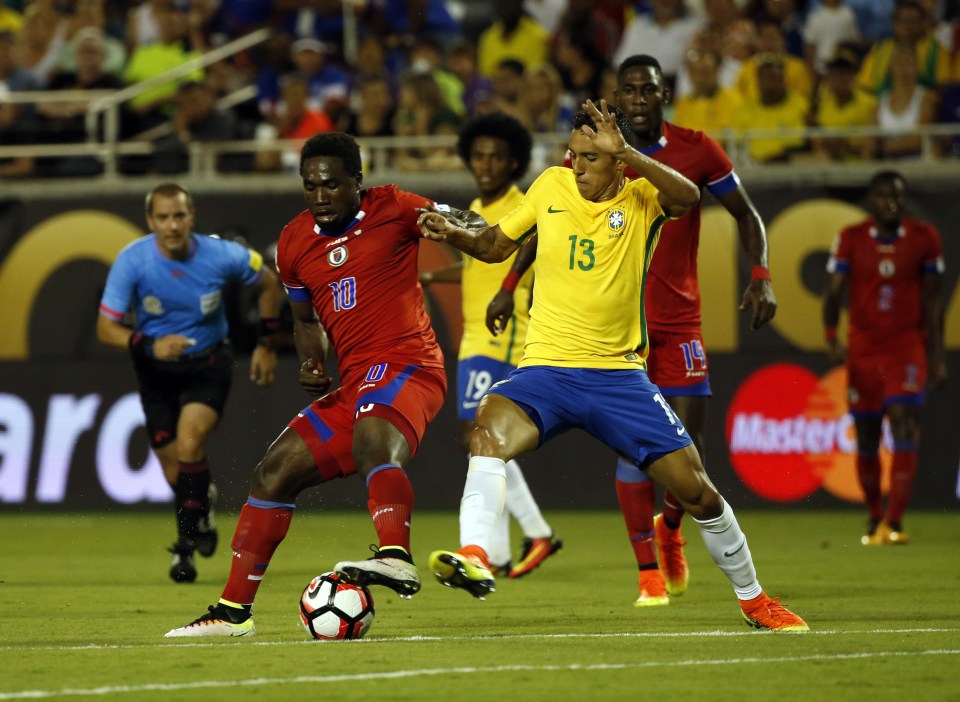  Marquinhos grapples with Haiti midfielder Jeff Louis