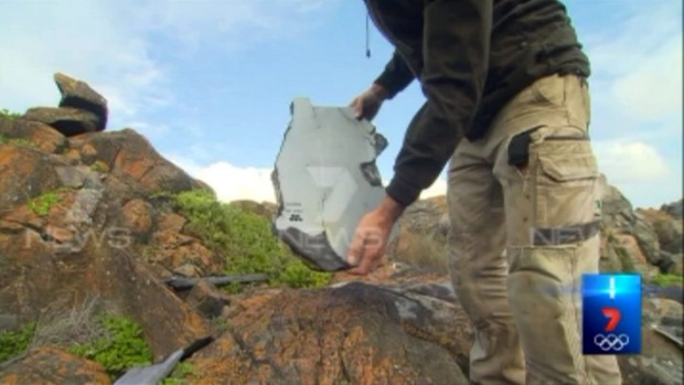  The fragment of white wreckage has a honeycomb symbol on along with printed words saying, “Caution no step”