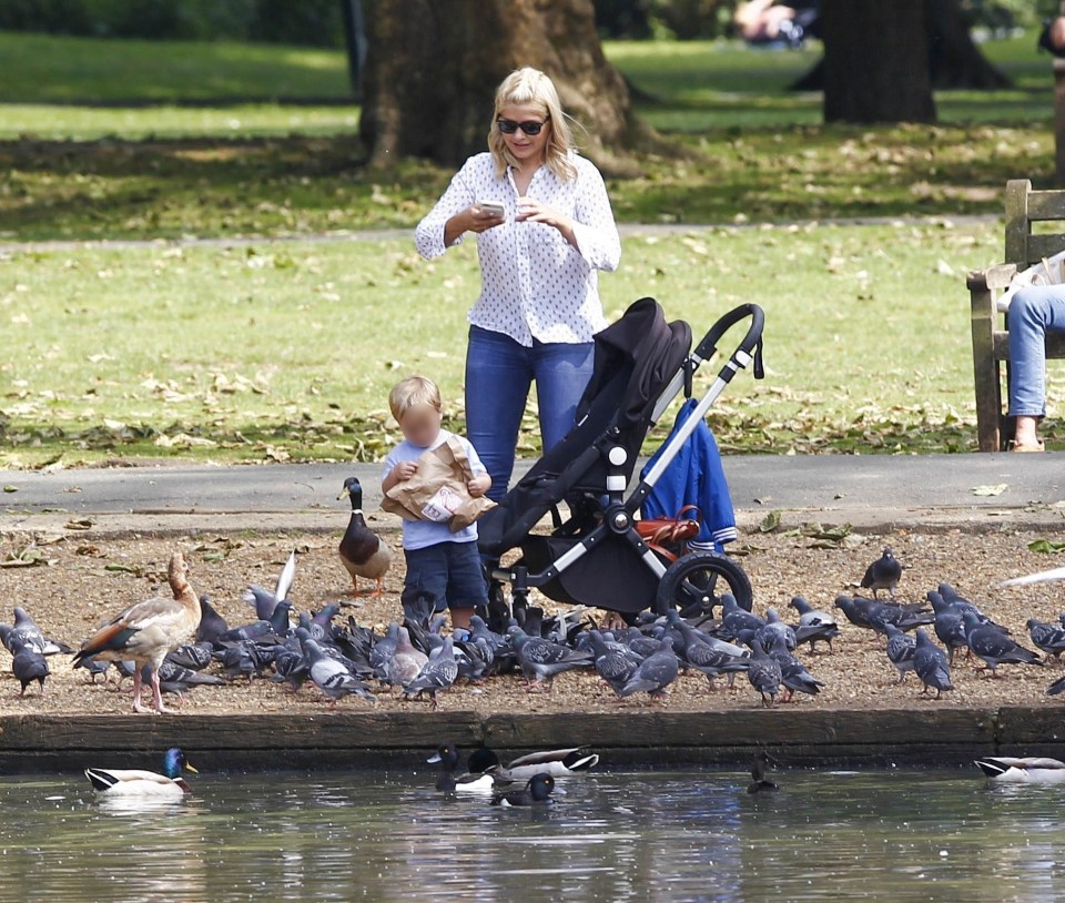  Holly snapped a picture of little Chester as he grabbed the bag of bread and began feeding the birds in the park