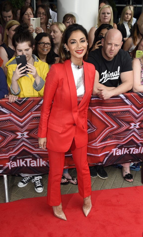 She looked sensational in a red trouser suit