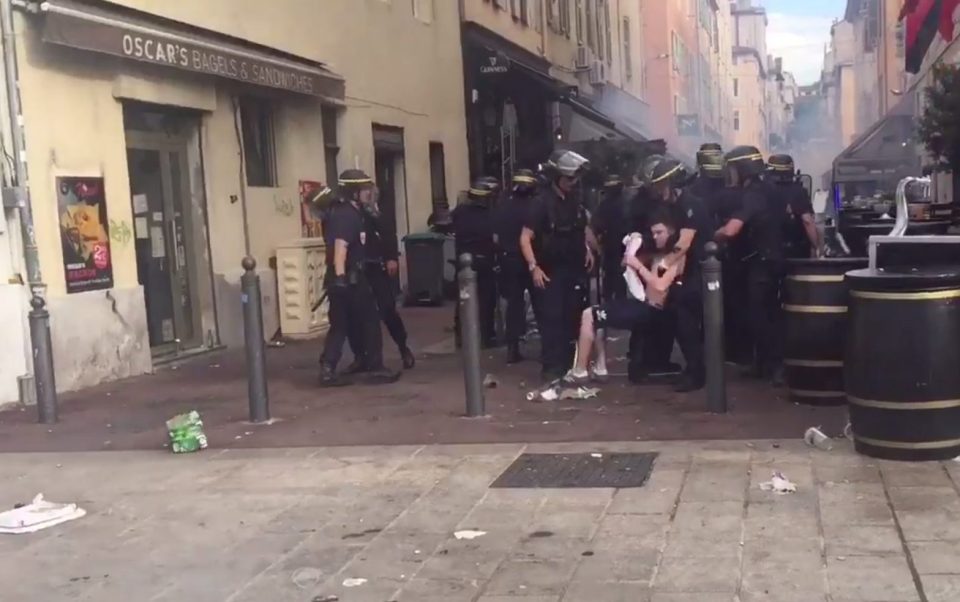  Fans are restrained by riot police outside the Queen Victoria pub in the Old Port