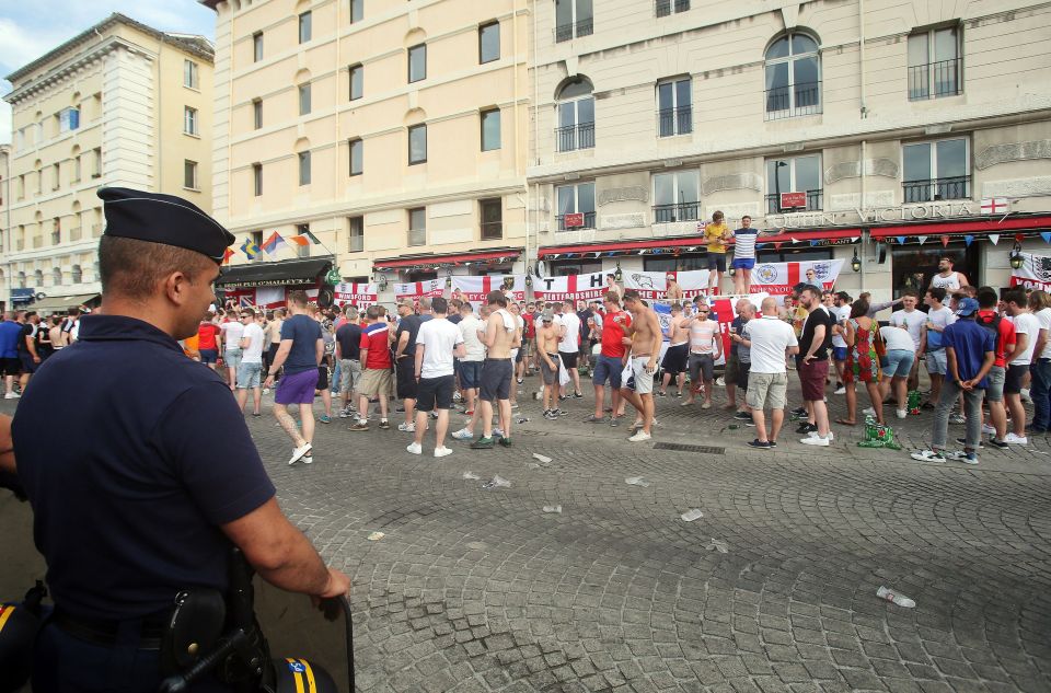  French police officers watch English football fans...outside Queen Victoria pub