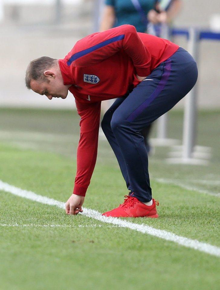 Wayne Rooney inspects the pitch ahead of England's draw with Russia