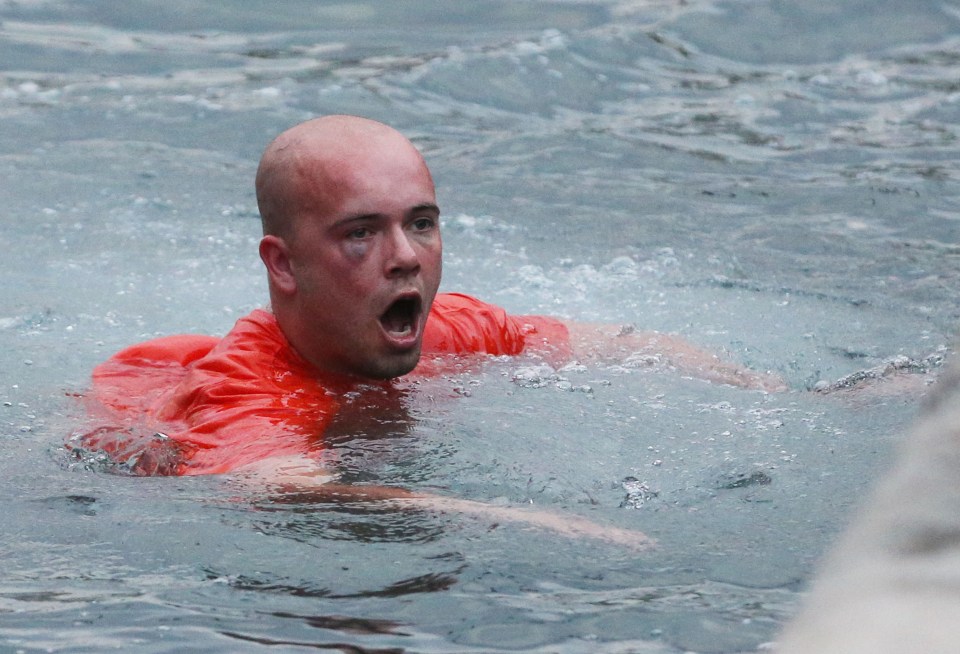  ...and swims to the shore after he is hurled over the harbour wall