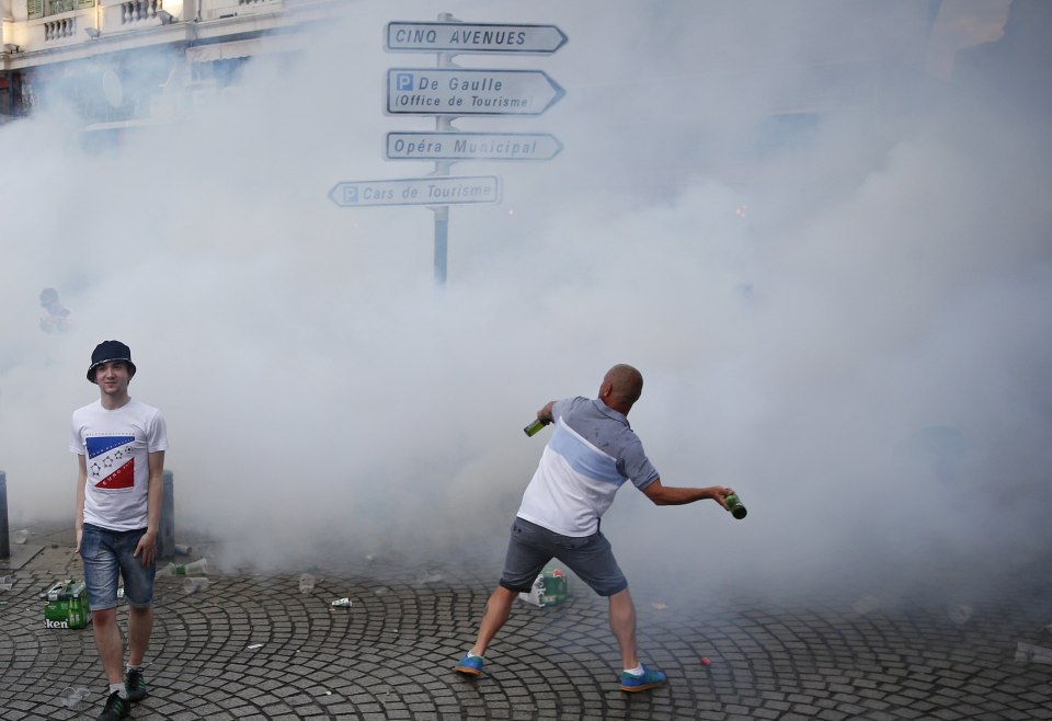  Riot police use tear gas against England supporters...as they try to fight back