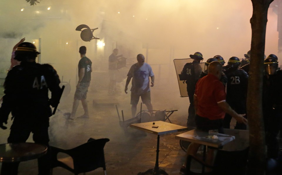  Riot police and fans go head to head...as chairs fly and tear gas is used