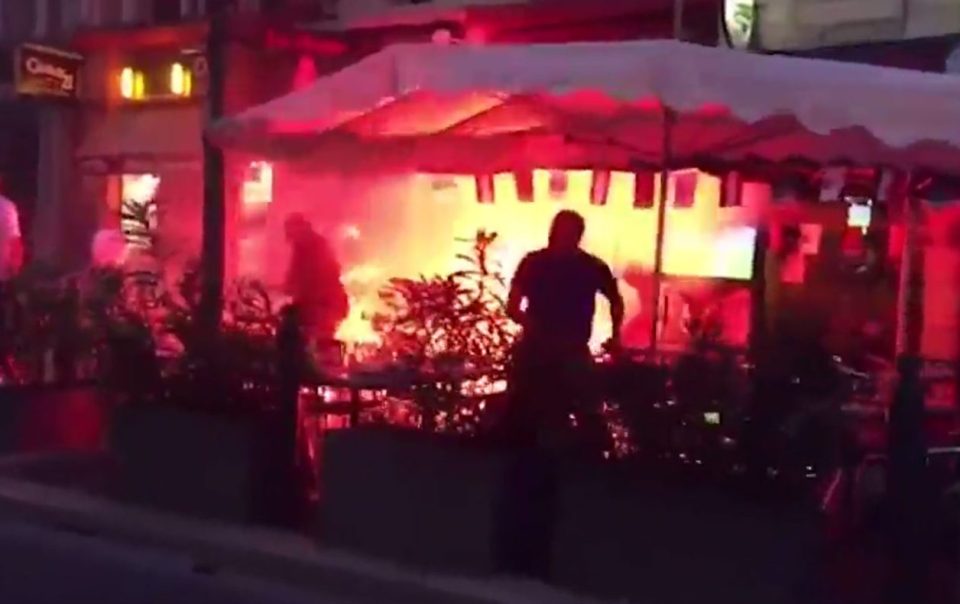  Angry England fan hurls a chair at mystery opponent...while fire rages