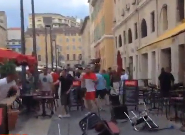  The England supporters respond by throwing objects back at the local thugs as they step back from the bar