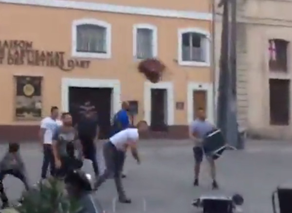  French hooligans approach England fans drinking at a bar an begin to pelt them with bottles and furniture