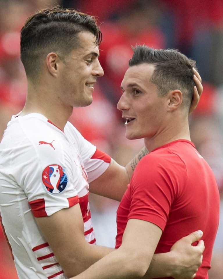  Granit and Taulant Xhaka swap shirts after facing each other