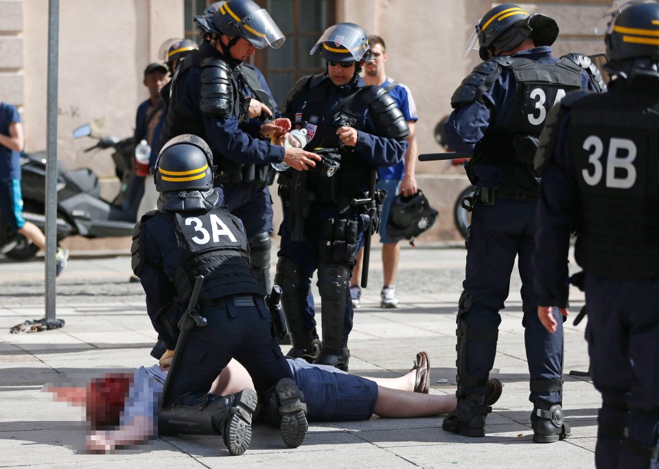  Cops desperately resuscitate an England fan after the Russian assault before their clash on the pitch