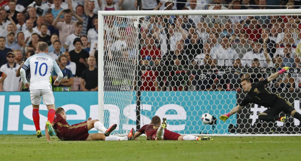 Igor Akinfeev somehow stretches to divert Wayne Rooney's effort against the crossbar