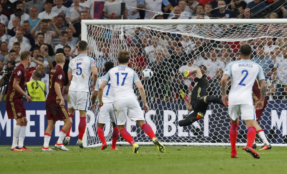 Eric Dier watches his free-kick beet Igor Akinfeev to give England the lead against Russia