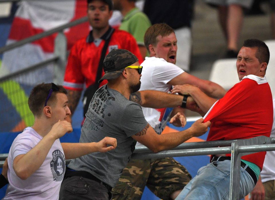  Ugly scenes ... England fans retaliate after Russian thugs cross over to the other side of the stadium