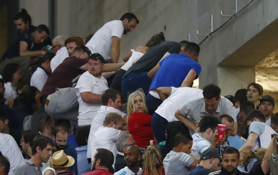  Bid to escape ... England fans climb fence to escape onslaught