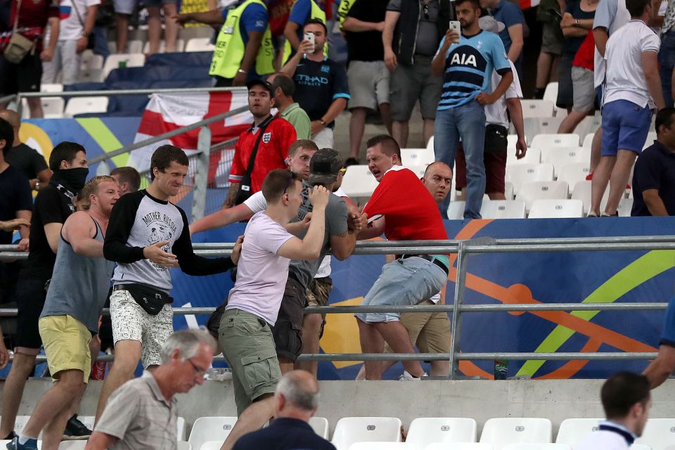  Utter panic ... football supporters trade blows in dramatic brawl