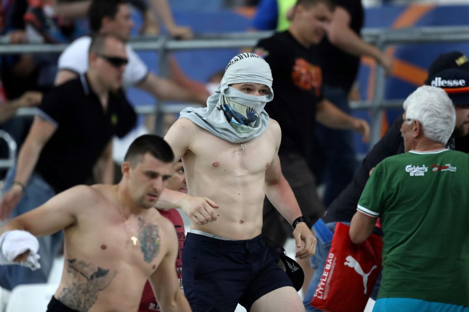  Masked ... Russian yobs throw punches on England fans