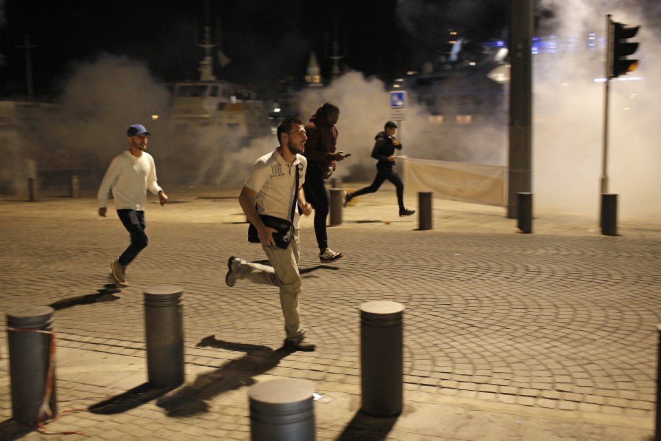 People run through the streets of Marseille, France after police fired tear gas 