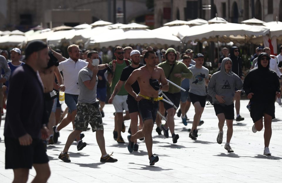  Russian fans run at England fans as they clash ahead of the game