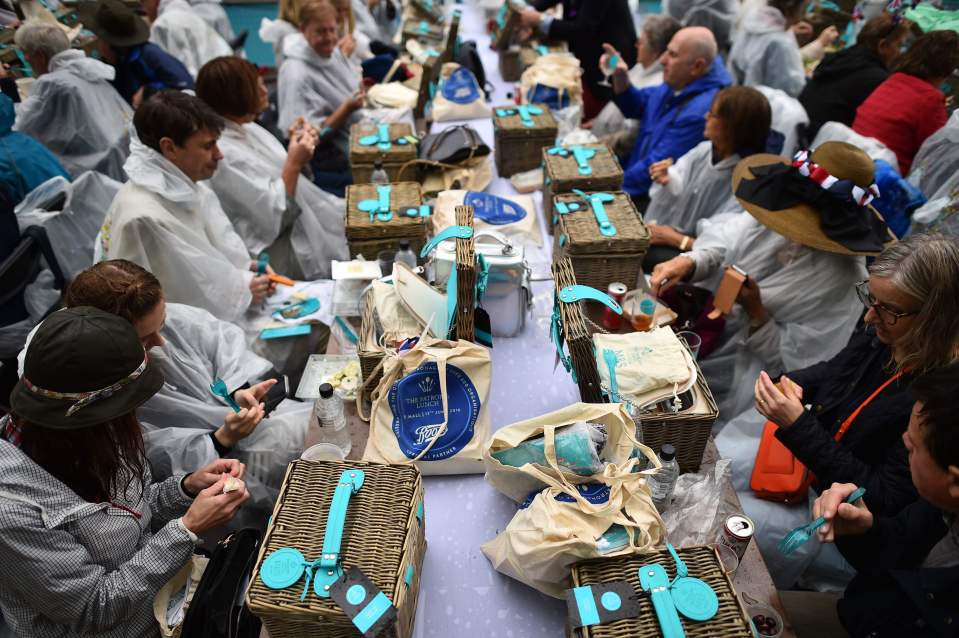 Guests enjoy their picnic hampers at the Patron's lunch outside the palace